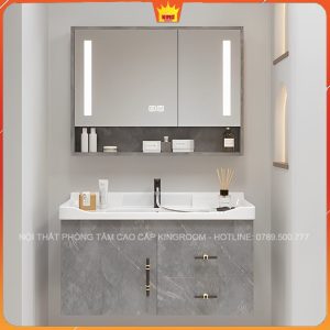 Tủ lavabo màu xám với gương chiếu sáng và chi tiết vàng nổi bật, phòng tắm sang trọng và đẳng cấp